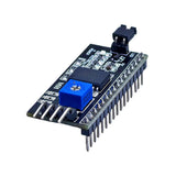 PCF8574 I2C LCD adapter angled view with contrast adjustment, backlight jumper and soldered header pins
