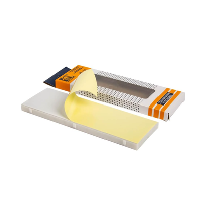 Close-up of breadboard with protective adhesive backing partially peeled