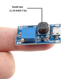Small ShillehTek MT3608 DC-DC step up booster held on fingertip