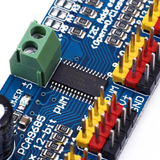 Close-up view of ShillehTek PCA9685 PWM driver chip and colored pin headers