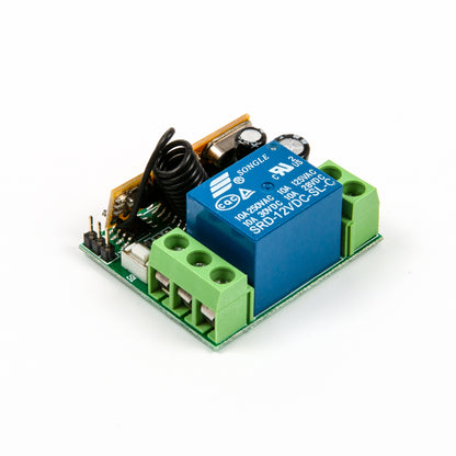 Close-up side view of relay module with visible blue relay and coil antenna