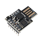 Close-up of ATtiny85 Digispark USB development board showing pins and electronic components