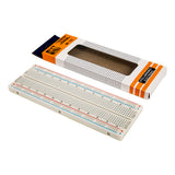 830-point white solderless breadboard with red and blue power rails and packaging box