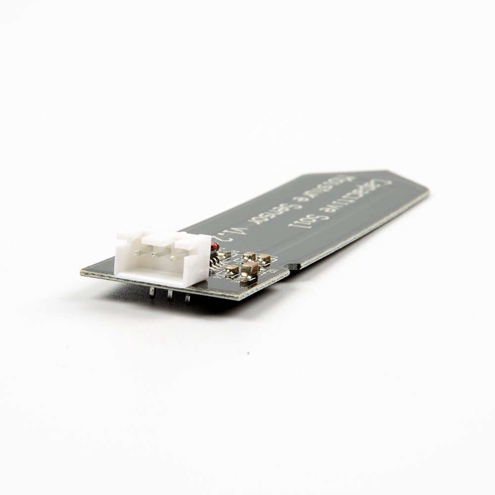 Capacitive Soil Moisture Sensor V1.2 showing white 3-pin connector and circuit components on black PCB