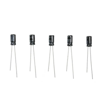 Five black electrolytic capacitors with long metal leads for electronic circuits