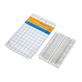 Open packaging with ShillehTek 400-point small solderless breadboard beside it