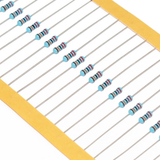Close-up of 1/4 watt 1% metal film resistors with color bands on a yellow paper strip