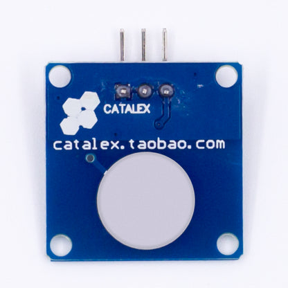 Back side of TTP223B capacitive touch switch sensor module with blue PCB and three pins
